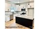 Bright kitchen with white cabinets, granite countertops, stainless appliances, and kitchen island at 210 Carolina Dr # 1000&999, Troy, NC 27371
