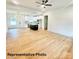 Spacious living room with wood-look floors and an open floorplan to the bright kitchen at 210 Carolina Dr # 1000&999, Troy, NC 27371