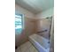 A full bathroom featuring a combination shower and tub, complete with safety bars for added accessibility and convenience at 215 Suncrest Rd, Cherryville, NC 28021