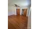 Bedroom features hardwood floors, ceiling fan, window, double door closet and two doors at 215 Suncrest Rd, Cherryville, NC 28021