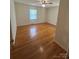 Bright bedroom features hardwood flooring, a ceiling fan, and a large window for natural light at 215 Suncrest Rd, Cherryville, NC 28021