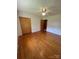 A serene bedroom featuring hardwood floors, a ceiling fan, a double door closet and natural light from the windows at 215 Suncrest Rd, Cherryville, NC 28021