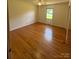 The bedroom features hardwood flooring, a ceiling fan, and a bright window, creating a comfortable atmosphere at 215 Suncrest Rd, Cherryville, NC 28021
