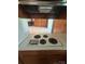 A vintage electric cooktop with four burners sits atop a kitchen counter, offering a glimpse into the home's cooking space at 215 Suncrest Rd, Cherryville, NC 28021