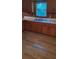 Traditional kitchen featuring wood cabinets, a stainless steel sink, and updated flooring at 215 Suncrest Rd, Cherryville, NC 28021