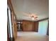 Cozy living room featuring wood paneled walls, a ceiling fan, and abundant natural light at 215 Suncrest Rd, Cherryville, NC 28021
