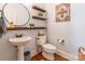 Stylish powder room featuring a pedestal sink, decorative shelves, and modern fixtures at 2166 Potpourri Pt, Rock Hill, SC 29732