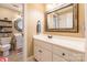 Bathroom features a vanity with a decorative mirror and an adjacent room with colorful shower curtain and shelves at 2166 Potpourri Pt, Rock Hill, SC 29732