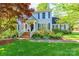 Inviting front porch with brick steps, white railings, and lush landscaping at 2166 Potpourri Pt, Rock Hill, SC 29732