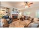 Cozy living room featuring a fireplace, built-in shelving, ceiling fan, and beautiful hardwood floors at 2166 Potpourri Pt, Rock Hill, SC 29732