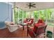 Relaxing screened-in porch featuring comfortable seating, outdoor ceiling fan, and serene forest backdrop at 2166 Potpourri Pt, Rock Hill, SC 29732