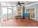 Inviting screened porch featuring a ceiling fan, tiled flooring, and space for entertaining with light blue walls at 2166 Potpourri Pt, Rock Hill, SC 29732