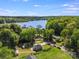 Scenic aerial view of a charming home surrounded by lush greenery and a serene lake in the background at 221 River Loop Rd, Belmont, NC 28012
