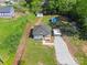 Aerial view of a cozy home with manicured lawns and tree coverage at 221 River Loop Rd, Belmont, NC 28012