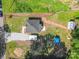 Aerial view of a charming home with gravel driveway and tree coverage at 221 River Loop Rd, Belmont, NC 28012