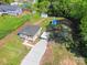 Aerial view of a single Gathering home and gravel driveway, surrounded by lush greenery at 221 River Loop Rd, Belmont, NC 28012