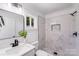 Bathroom featuring white marble tile in the shower, modern fixtures, and vanity with a sleek mirror at 221 River Loop Rd, Belmont, NC 28012