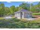 Charming cottage-style home with a manicured lawn, gravel driveway, and freshly painted siding at 221 River Loop Rd, Belmont, NC 28012