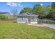 Charming single-story home with a small front porch, vibrant turquoise door and shutters, and a well-maintained lawn at 221 River Loop Rd, Belmont, NC 28012