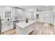 Bright, modern kitchen with stainless steel appliances, white cabinets, an island, and hardwood floors at 221 River Loop Rd, Belmont, NC 28012