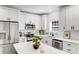 Bright kitchen featuring white cabinets, stainless steel appliances, marble countertops, and modern fixtures at 221 River Loop Rd, Belmont, NC 28012