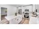 Bright modern kitchen featuring an island, stainless steel appliances, white cabinets, and hardwood floors at 221 River Loop Rd, Belmont, NC 28012
