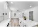 Bright, open kitchen with an island, stainless steel appliances, hardwood floors, and white cabinets at 221 River Loop Rd, Belmont, NC 28012