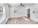 Bright living room with natural light, wood-look flooring, fresh paint, and a stylish ceiling fan at 221 River Loop Rd, Belmont, NC 28012