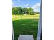 View of a spacious green backyard with fresh grass, with a small white house in view at 2231 Catawba Trace Dr, Catawba, NC 28609