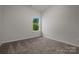 Bright bedroom features plush carpet, a window with a view of greenery, and neutral paint at 2231 Catawba Trace Dr, Catawba, NC 28609