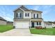 Charming two-story home with a two-car garage, dark blue shutters, and landscaped front yard at 2231 Catawba Trace Dr, Catawba, NC 28609