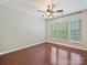 Bedroom featuring hardwood floors, neutral paint, a ceiling fan, and a large window providing natural light at 2268 Kensington Station Pkwy, Charlotte, NC 28210