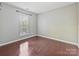 Bedroom featuring hardwood floors, neutral paint, and a large window providing natural light at 2268 Kensington Station Pkwy, Charlotte, NC 28210