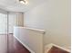 Upper level hallway featuring hardwood floors, neutral paint, and easy access to bedrooms and living spaces at 2268 Kensington Station Pkwy, Charlotte, NC 28210