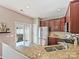 Modern kitchen featuring stainless steel appliances, granite countertops, and dark wood cabinets at 2268 Kensington Station Pkwy, Charlotte, NC 28210