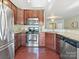 Updated kitchen with stainless steel appliances, granite countertops, and hardwood floors at 2268 Kensington Station Pkwy, Charlotte, NC 28210