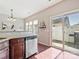 Kitchen with stainless steel dishwasher and a sliding door to a fenced backyard with a grill at 2268 Kensington Station Pkwy, Charlotte, NC 28210