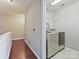 Bright laundry room features a modern washer and dryer on light tile flooring with gray painted walls at 2268 Kensington Station Pkwy, Charlotte, NC 28210