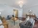 Bright living room featuring hardwood floors, neutral paint, a crystal chandelier, and an open floor plan at 2268 Kensington Station Pkwy, Charlotte, NC 28210