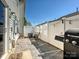 Outdoor patio features a grill, string lights, privacy fence, and pavers, great for entertaining at 2268 Kensington Station Pkwy, Charlotte, NC 28210