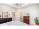 Bright bedroom with ensuite bathroom access, neutral walls, and tray ceiling at 2410 Dr Carver Rd, Charlotte, NC 28208