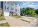 Attractive townhouses with attached garages, complemented by manicured lawns and a long driveway at 2410 Dr Carver Rd, Charlotte, NC 28208