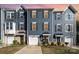 Charming blue townhouse with well-manicured lawn and inviting entrance; a great curb appeal and modern design at 2410 Dr Carver Rd, Charlotte, NC 28208