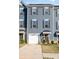 Beautiful three-story townhouse with attached garage and front lawn, perfect for modern living at 2410 Dr Carver Rd, Charlotte, NC 28208