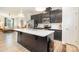 Stylish kitchen with a large center island, sleek black cabinetry, stainless steel appliances, and open layout at 2410 Dr Carver Rd, Charlotte, NC 28208