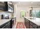 Modern kitchen with white subway tile backsplash, island with sink, and stainless steel appliances at 2410 Dr Carver Rd, Charlotte, NC 28208