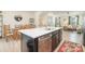Bright, open-concept kitchen with a large island, stainless steel dishwasher, and view of the dining and living areas at 2410 Dr Carver Rd, Charlotte, NC 28208
