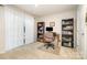 Cozy office features a large window, dual bookshelves, and neutral carpet, perfect for working from home at 2410 Dr Carver Rd, Charlotte, NC 28208