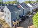 Back view of the blue townhouse with a wooden decks, perfect for outdoor gatherings and enjoying nature at 2410 Dr Carver Rd, Charlotte, NC 28208