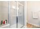 Modern bathroom shower featuring glass enclosure and sleek tile at 2410 Dr Carver Rd, Charlotte, NC 28208